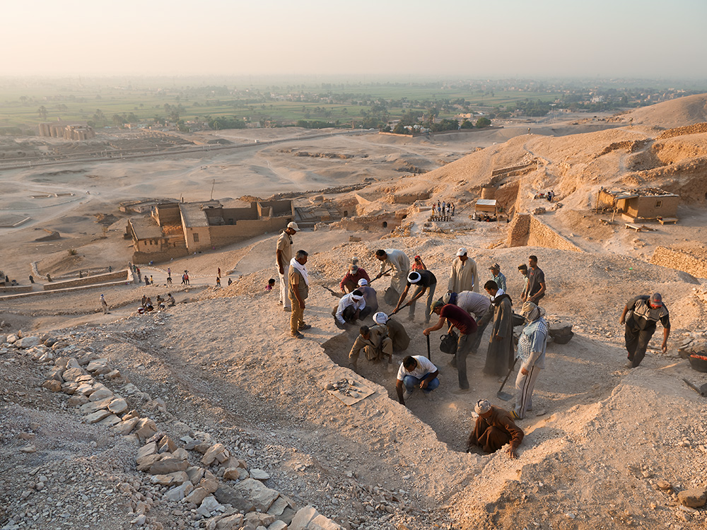 local field assistants working on excavating a tomb local field assistants working on excavating a tomb